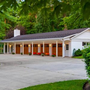 A white six-car garage turned guesthouse and AirBnB Lodging property